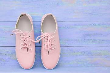 women's pink shoes. On a blue wooden background.