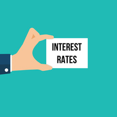 Man showing paper INTEREST RATES text