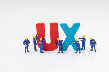 UX User Experience development and design concept, miniature people workers team building the...