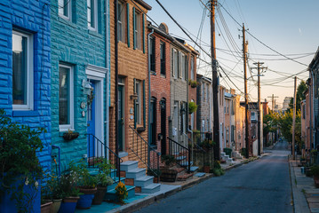 Fototapeta na wymiar Colorful row houses along Chapel Street in Butchers Hill, Baltimore, Maryland.