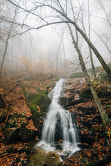 Fototapeta na wymiar Crabtree Falls on a foggy autumn day, in George Washington National Forest near the Blue Ridge Parkway in Virginia.
