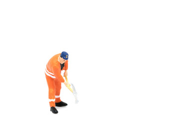 Miniature people worker wearing safety construction on white background with a space for text