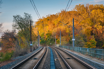 Fototapeta na wymiar Light Rail tracks and autumn color in Baltimore, Maryland.