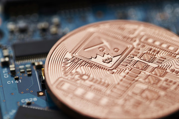 Cryptocurrency coin on circuit board 