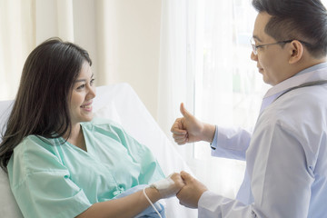 Doctors hold hands to encourage patients in the hospital- medical concept