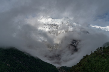 Annapurna II peaks out behind some clouds