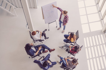 Top view of creative manager presenting the creative ideas in front of Group Of Asian Business people with casual suit in happy action in the modern workplace
