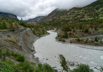 Fototapeta na wymiar The Marsyangdi River snakes its way between upper and lower Pisang in Nepal