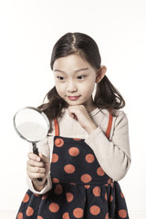 a girl hand hold a magnifier isolated white.