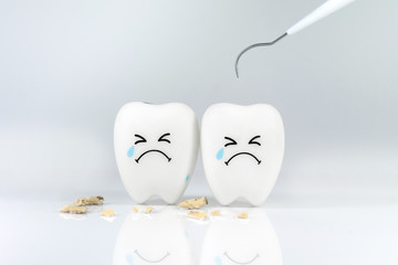 Teeth crying emotion with dental plaque tool ,Concept Dental care cleaning bacterial plaque
