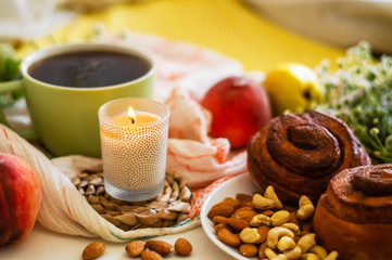 Breakfast in bed, a tray of tea, croissants, fruit, flowers. Morning. Cozy Apartment. Romance. bright Background layout. a day off