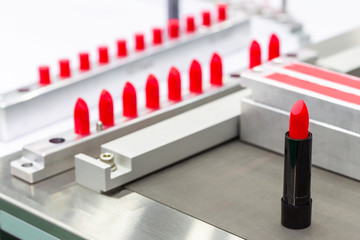 A lipstick vial filling machine in a cosmetics factory.