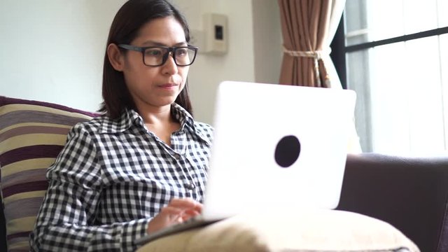 Woman taking off glasses tired of laptop computer work, Suffering from eye strain tension or blurry vision problem concept, slow motion
