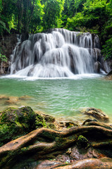 Fototapeta na wymiar Beautiful waterfall in tropical rainforest at Kanchanaburi province, Thailand
