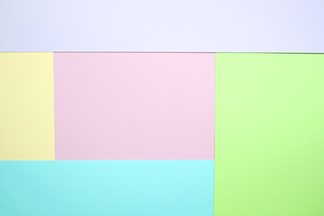 Fototapeta premium Fashionable pastel colored paper flat lay top view, geometric background texture, pink, purple, yellow, beige, green and blue.