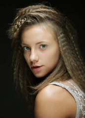 Blonde girl with curly hair. Beautiful model woman with wavy hairstyle
