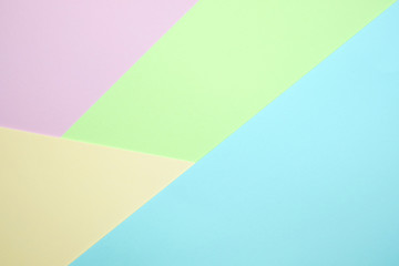 Obraz premium Fashionable pastel colored paper flat lay top view, geometric background texture, pink, purple, yellow, beige, green and blue.