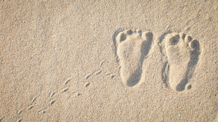 The little cute footprint of baby on the sand.
