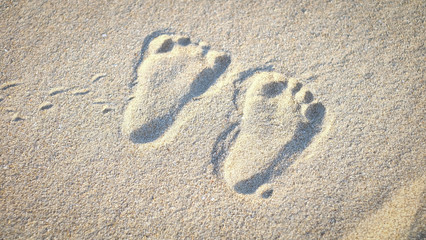 The little cute footprint of baby on the sand.