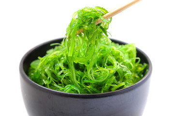 Hiyashi Wakame Chuka or seaweed salad in black bowl on white background ,Japanese food