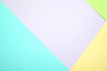 Fashionable  pastel colored paper flat lay top view, geometric background texture, pink, purple, yellow, beige, green and blue.