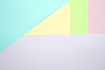 Obraz premium Fashionable pastel colored paper flat lay top view, geometric background texture, pink, purple, yellow, beige, green and blue.