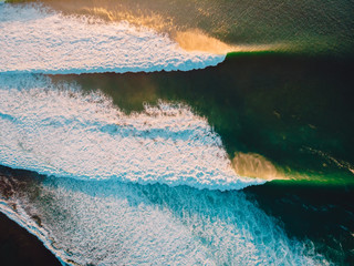 Aerial shooting of stormy waves at sunset. Biggest ocean wave