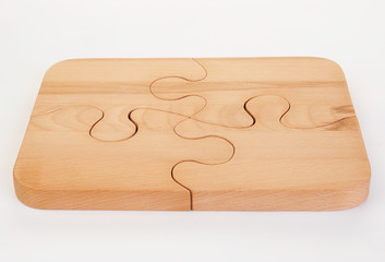Wooden puzzle board on white background.
