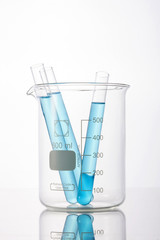 beaker and cylinder closeup isolated white.