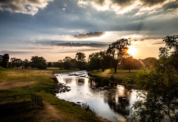 Spectacular sunset landscape with starburst of the surrounding area near Brougham Castle in...