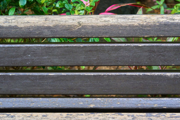 Fragment of shabby wooden aged black painted backrest of old par