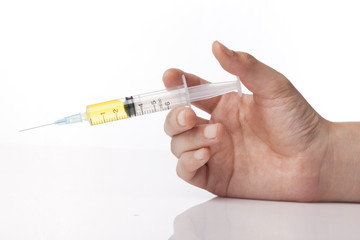 hand hold a syringe isolated white.