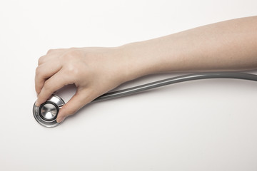 hand hold a stethoscope on the white background.