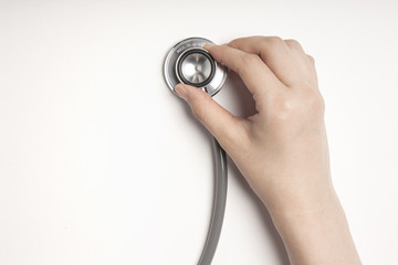 hand hold a stethoscope on the white background.