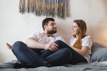 Lovely couple have fun, rest and relax on the bed together