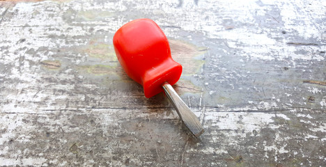 screwdriver on an old painted wod background