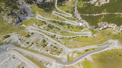 Road to the Stelvio mountain pass in Italy. Amazing aerial view of the mountain bends creating...