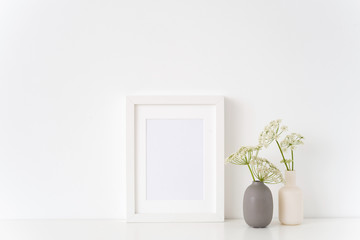 Stylish white portrait a5 frame mock up with a Aegopodium in vases on white background. Mockup for quote, promotion, headline, design. Template for small businesses, lifestyle bloggers, social media
