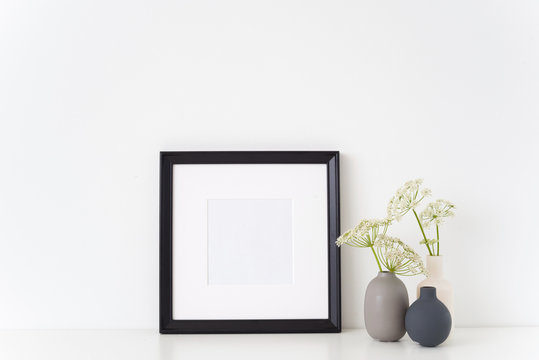 Black portrait square frame mock up with a episcopal weed in little vases. Mockup for quote, promotion, headline, design. Template for small businesses, lifestyle bloggers, social media