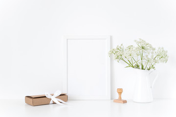 White frame mock up with a herbal in vase, gift box. Mockup for design.Template for businesses, lifestyle bloggers,media
