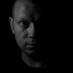 Black and white dramatic portrait of a man in a low key style.