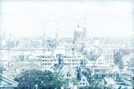 View of Amsterdam with a cloudy sky and snow