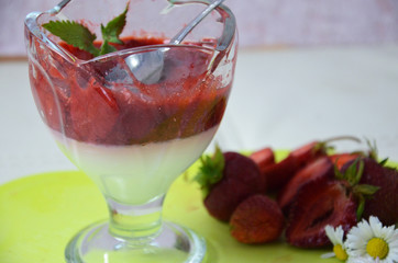 Italian dessert panna cotta with fresh strawberries or yogurt or pudding on a green napkin
