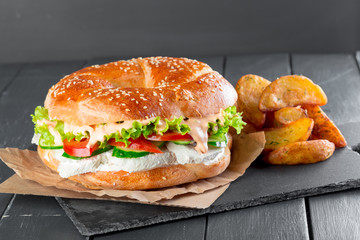 Hamburger with fries on a slate plate