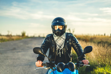 Obraz na płótnie Canvas Man on sport motorcycle outdoor on the road