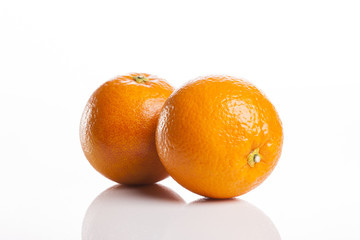two fresh oranges close up isolated white.