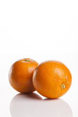 two fresh oranges close up isolated white.