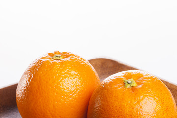 oranges on the wood tray isolated white.