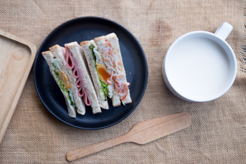 Sandwich with brown bread served with fresh milk