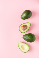 Half and full raw avocado minimalism pastel - obrazy, fototapety, plakaty